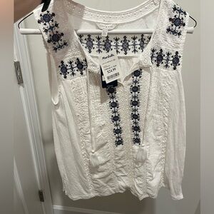 White top with some blue detail